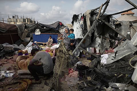 Palestinians inspect their destroyed tents